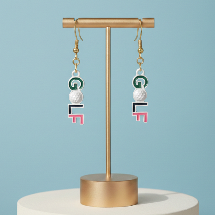 Pair of earrings on a gold stand against a light blue background