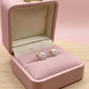 Pink jewelry box with pearl earrings on a pink background